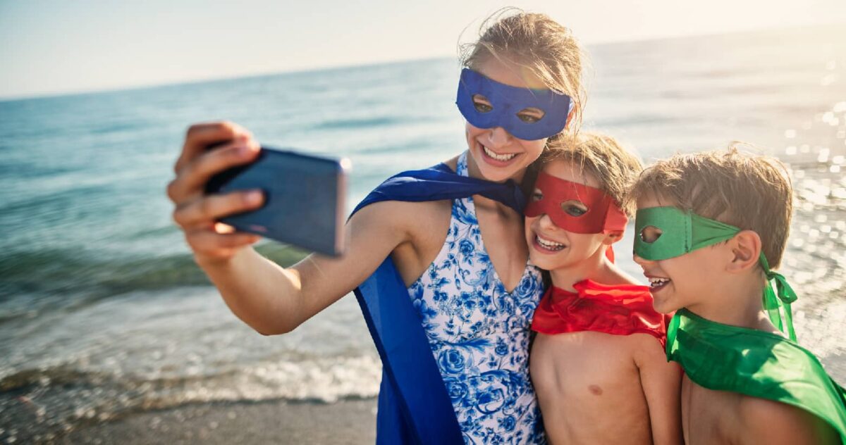 A family taking a photo together using a mobile phone